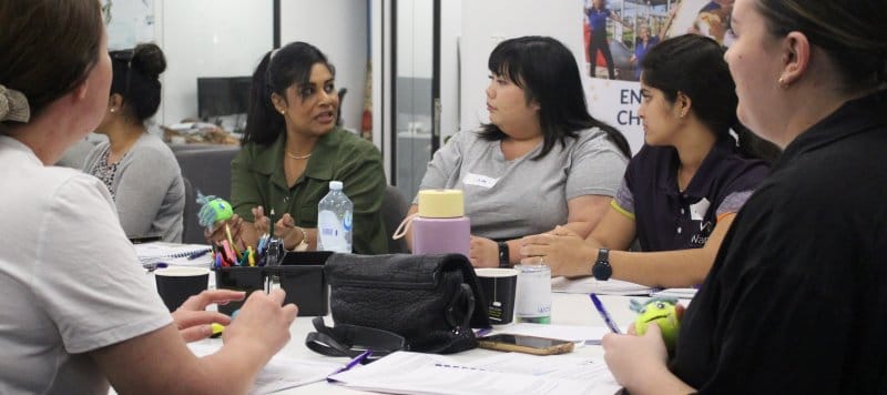 A group of teachers sitting around a table having a discussion