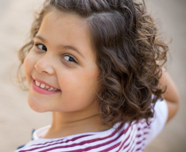 child looking back at the camera smiling