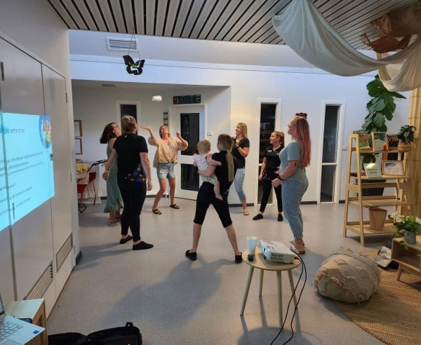 Educators and babies dancing in a circle