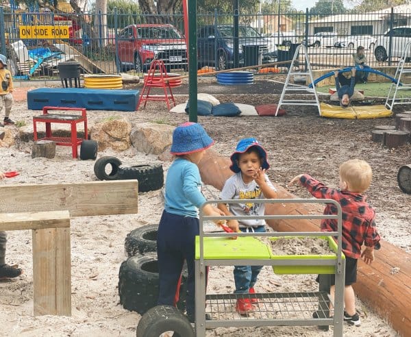 Children outside, playing with sand
